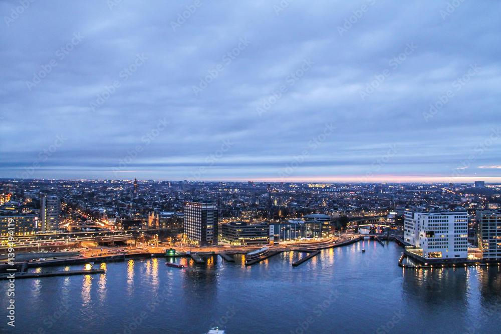 Dusk view over the river on to City of Amsterdam, Netherlands