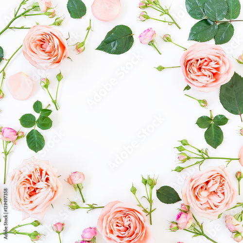 Round floral frame with beautiful roses and leaves on white background. Flat lay, top view. Floral background