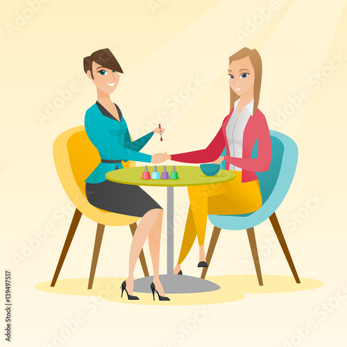 Woman receiving manicure in nail salon.