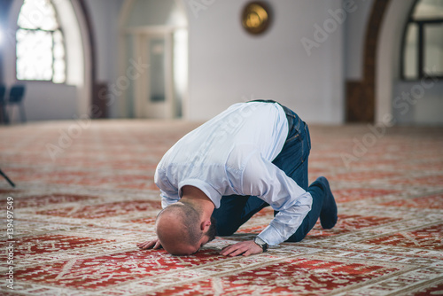 Humble Muslim prostrating in prayer