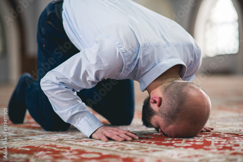 Humble Muslim prostrating in prayer