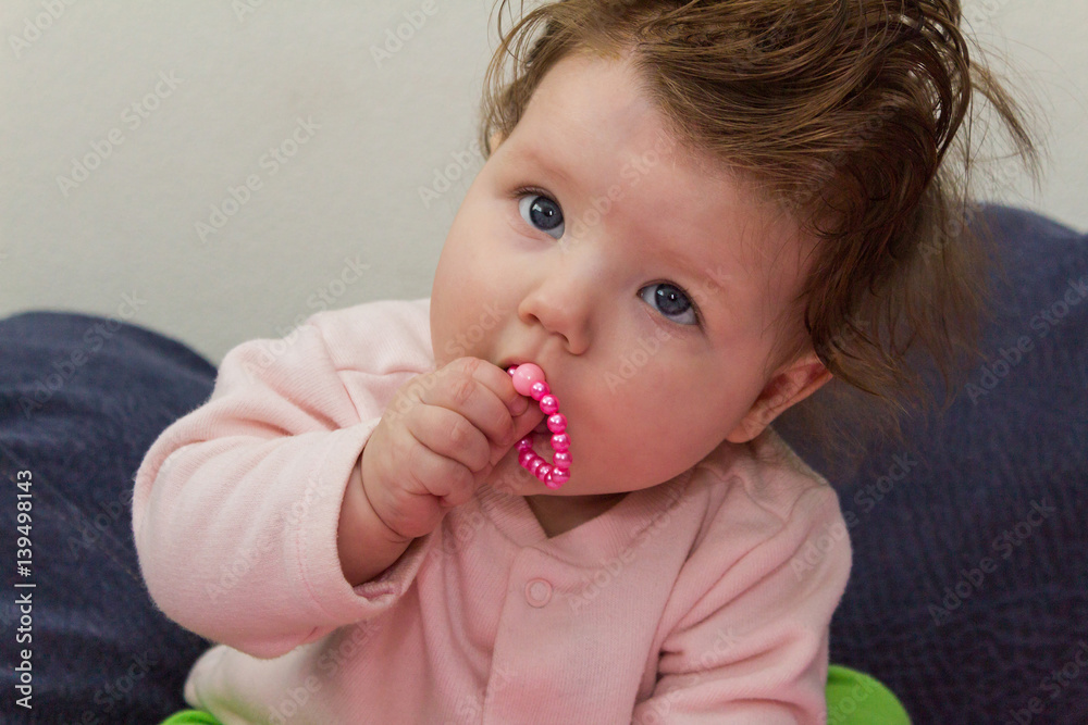Baby sitting and chewing on the beads. Baby sitting and chewing on the beads.