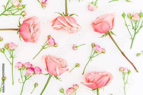 Floral background. Floral pattern of pink roses on white background. Flat lay, top view.