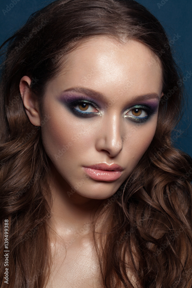 Beautiful young brunet model with perfect makeup and long hair. Gorgeous Woman Face. Bright makeup. Beautiful young brunet model with perfect makeup and long hair. Gorgeous Woman Face. Bright makeup.