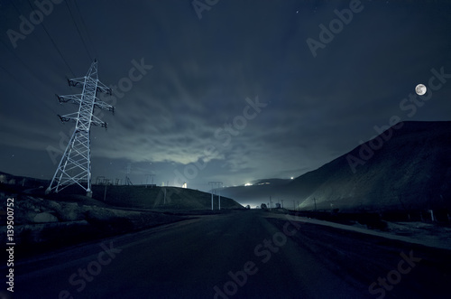 Beautiful night landscape of big full moon rising over the mountain road with hill and trees. Forest and mountains of south part of Azerbaijan. Masalli Yardimli photo