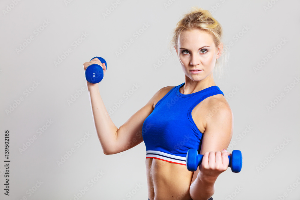 Fit woman lifting dumbbells weights Fit woman lifting dumbbells weights