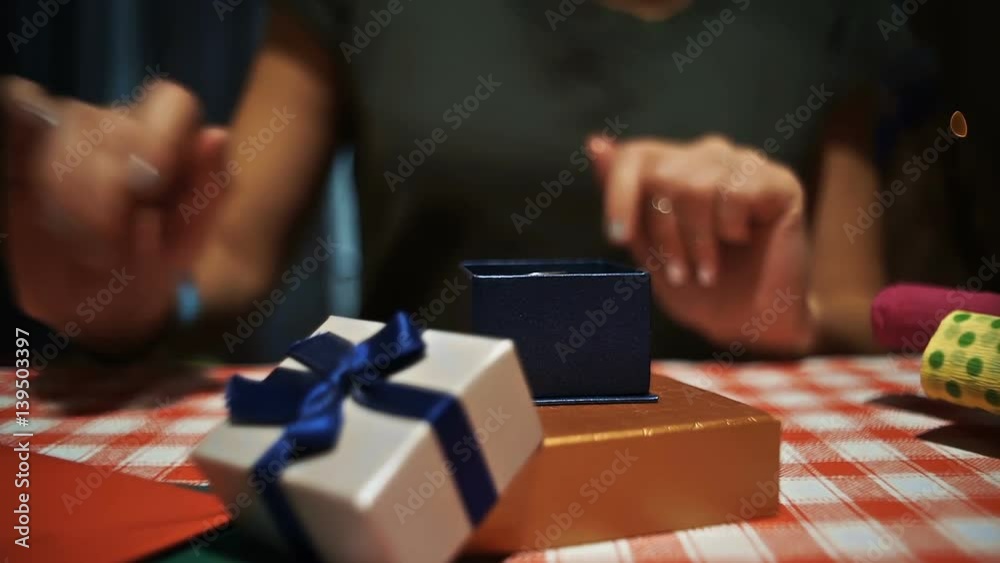 Female opening a small blue secret present box and taking a photo on smartphone hd Female opening a small blue secret present box and taking a photo on smartphone hd