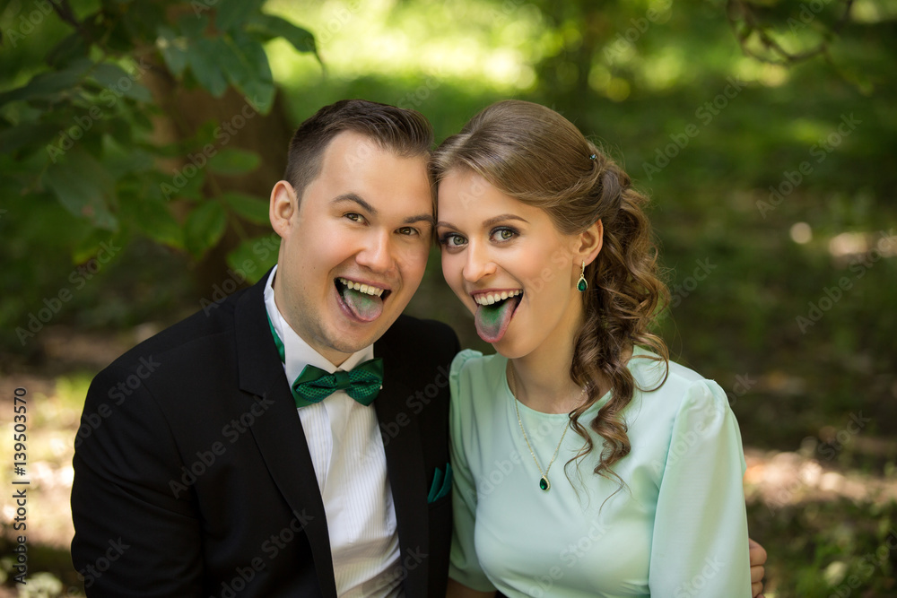 Man and woman grimacing with green tongues. Green wedding or saint patrick day concept Man and woman grimacing with green tongues. Green wedding or saint patrick day concept