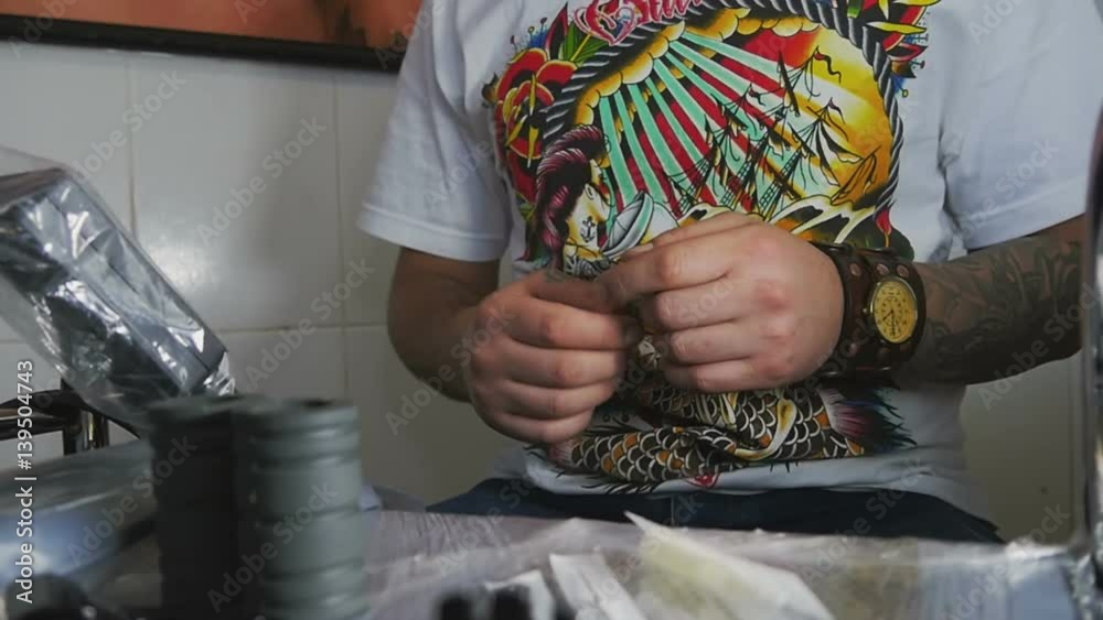 Man with tattoos puts on gloves close-up. Slow motion Man with tattoos puts on gloves close-up. Slow motion