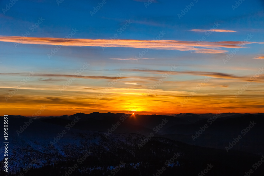 Beautiful sky sunset in winter mountains. Carpathian. Ukraine. Europe