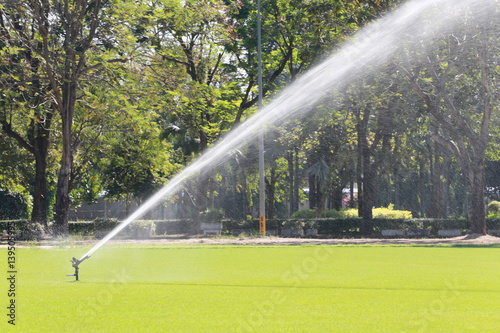 Sprinkler in Watering green lawn of golf courses.