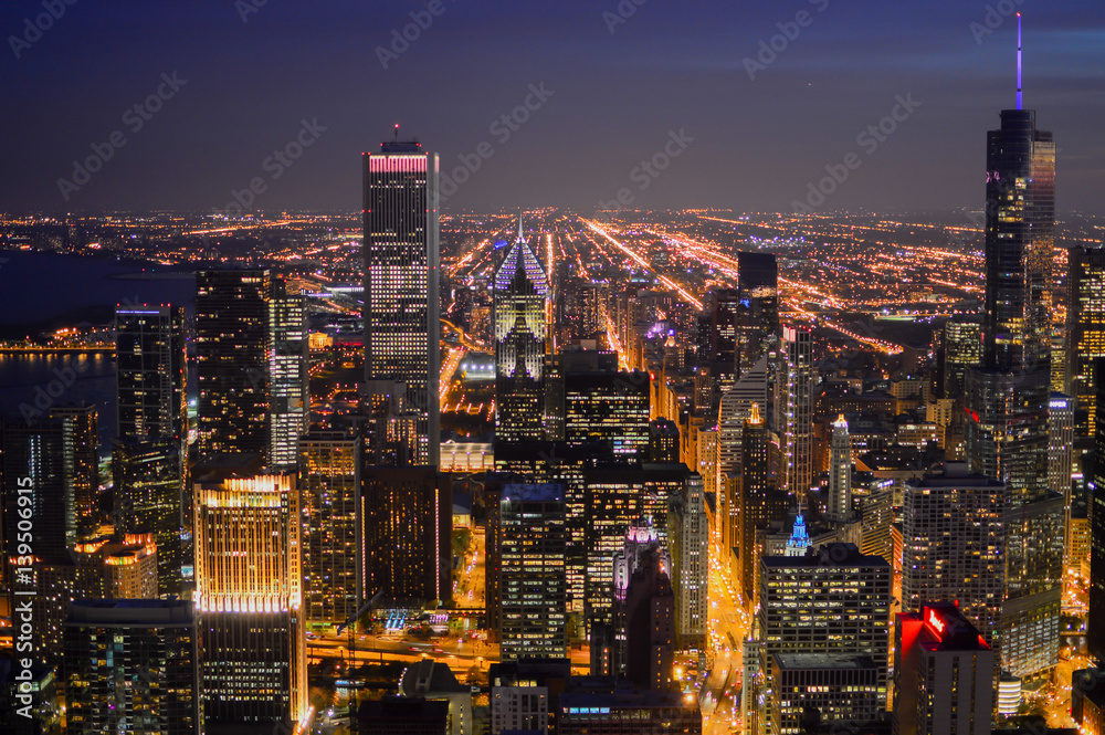 view of the Chicago city at night with skyscrapers lit