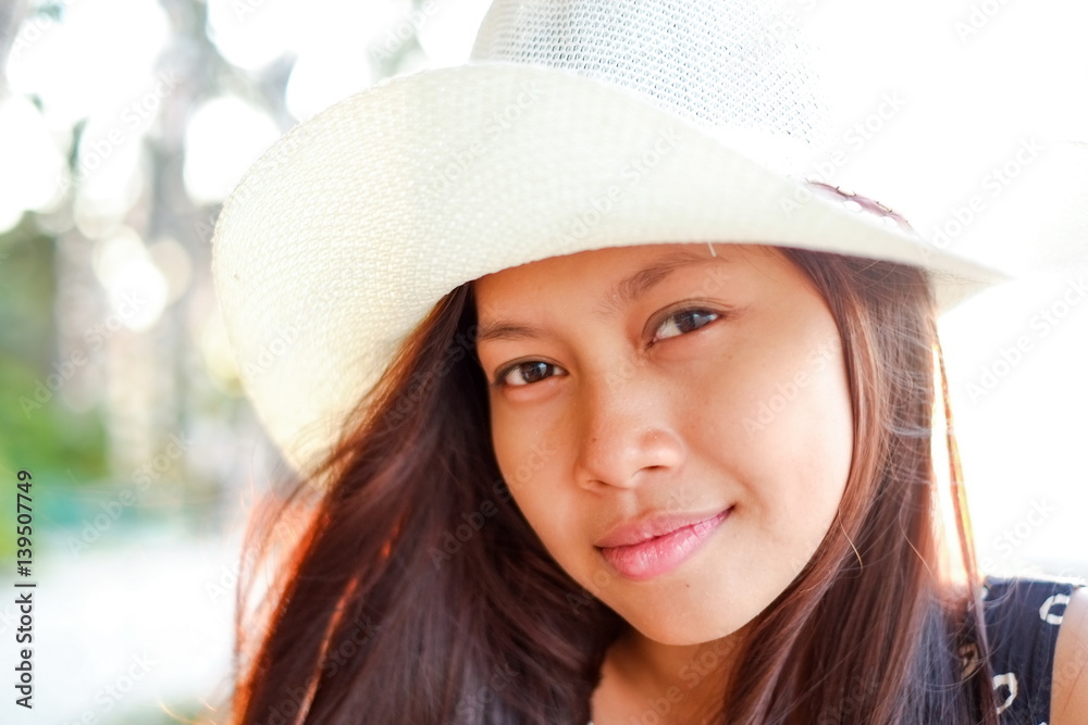 Summer portrait of a beautifull asian girl in white hat Summer portrait of a beautifull asian girl in white hat