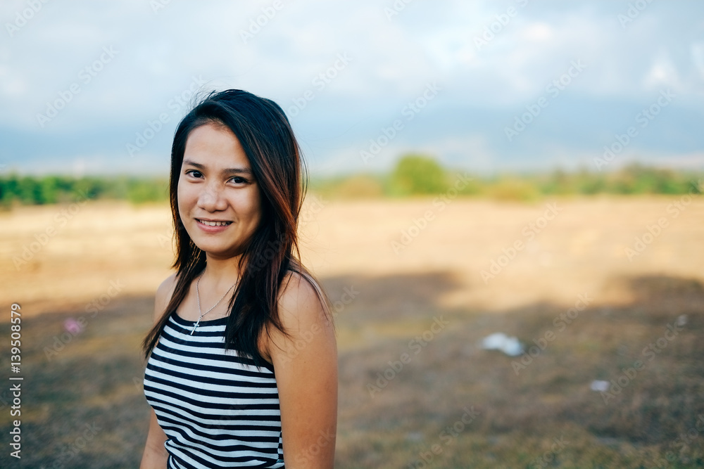 Beautiful portrait of young Asian woman smiling, with nice sunlight Beautiful portrait of young Asian woman smiling, with nice sunlight