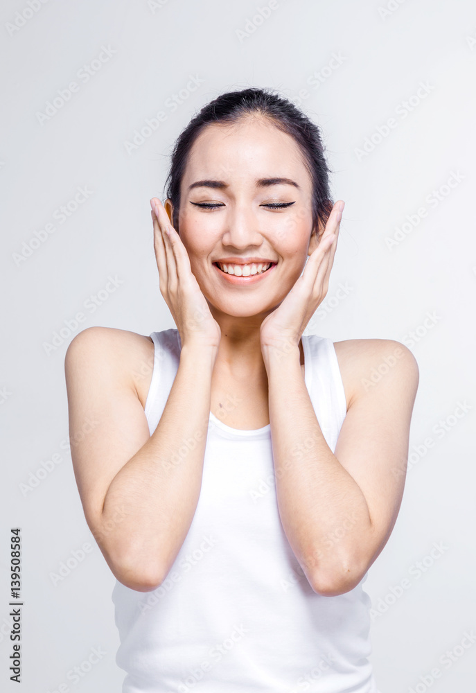 Beautiful woman cares for the skin face - posing at studio isolated on white background Beautiful woman cares for the skin face - posing at studio isolated on white background