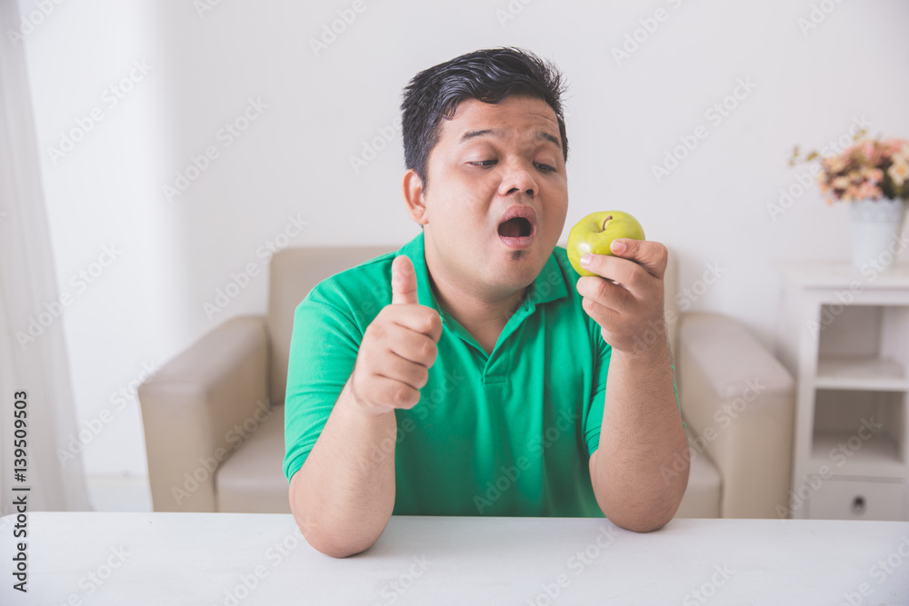 obese man trying to eat healthy fresh food obese man trying to eat healthy fresh food