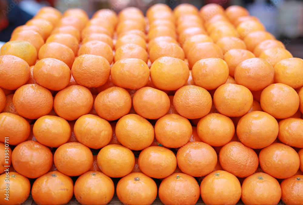 Closeup of many oranges on a fruit shop in market