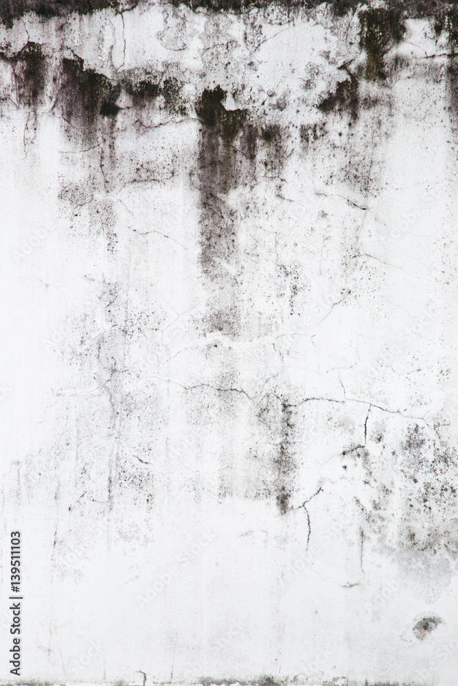 Fototapeta premium Texture of grey concrete wall with dark water marks running vertically down and many marks and lines