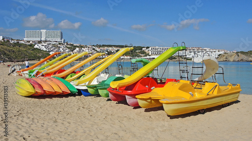 Wallpaper Mural Group of colorful pedal boats with and without slide on the beach of Arenal d'en Castell, Menorca Island, Spain. Torontodigital.ca