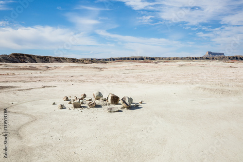 Broken boulder in smooth flat desert plain