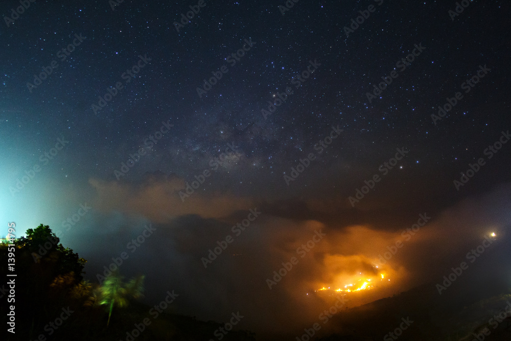 Milky way galaxy over foggy mountains at Phutabberk Phetchabun in Thailand. Long exposure photograph.