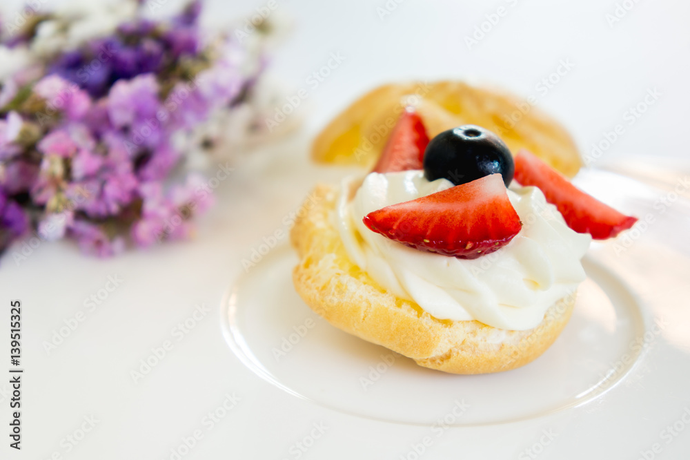 Homemade, Homemade cake, Choux Cream with fresh blueberry and strawberry decorated on white background at house. Homemade, Homemade cake, Choux Cream with fresh blueberry and strawberry decorated on white background at house.