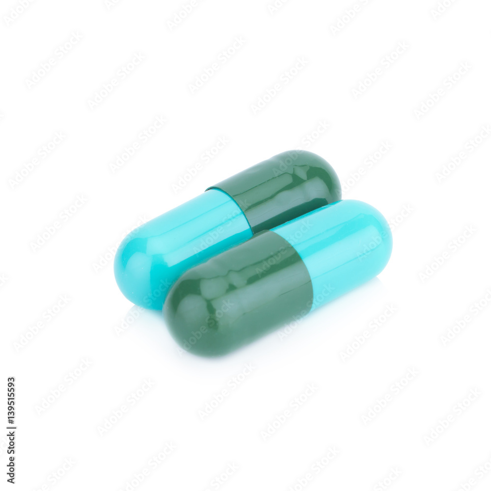 Two capsule color green and blue isolated on white background Two capsule color green and blue isolated on white background