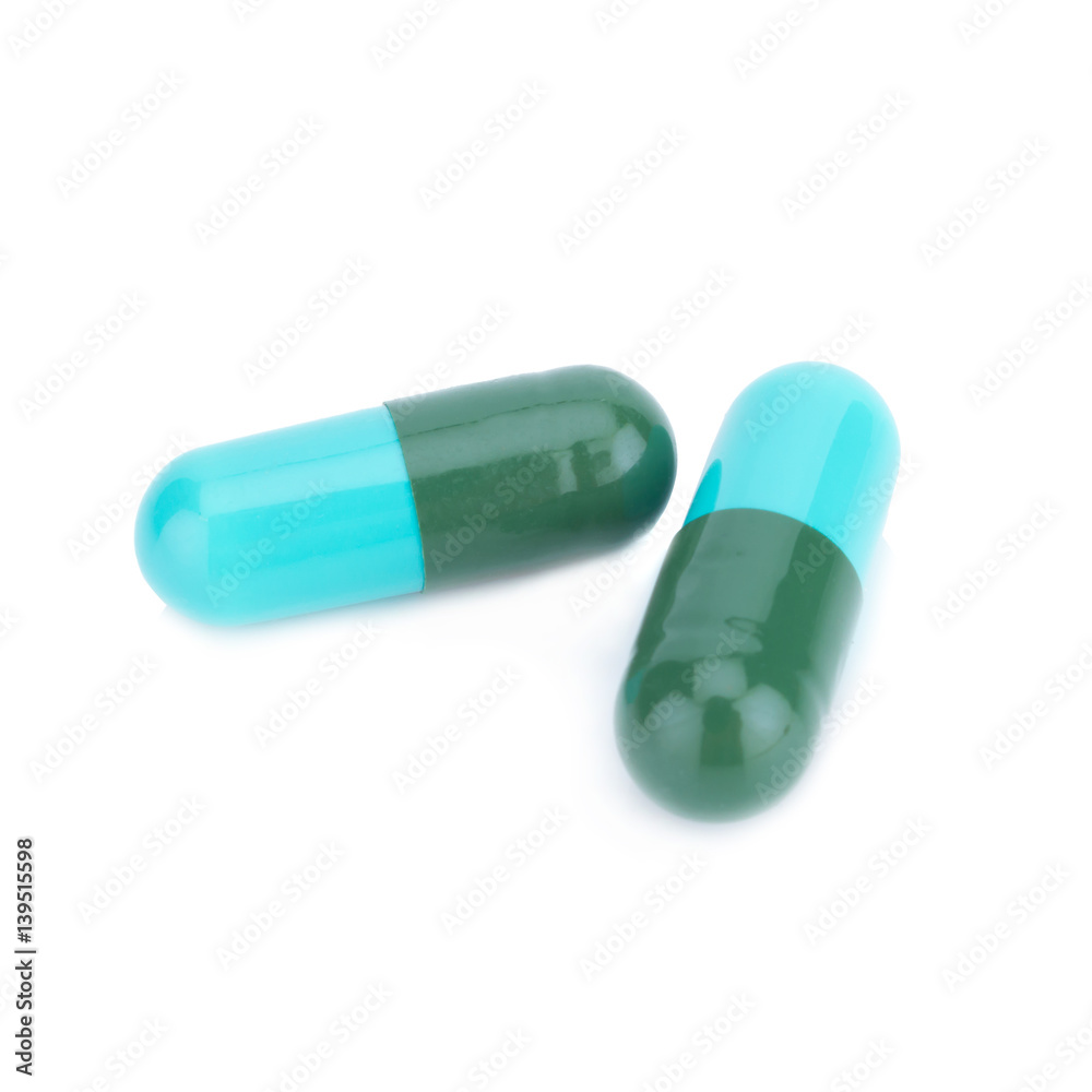 Two capsule color green and blue isolated on white background Two capsule color green and blue isolated on white background