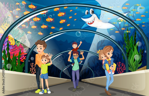 People looking at fish in the aquarium