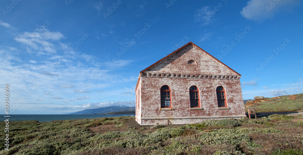 Fototapeta premium Red Brick Fog Signal Building at the Piedras Blancas Lighthouse on the Central California Coast US