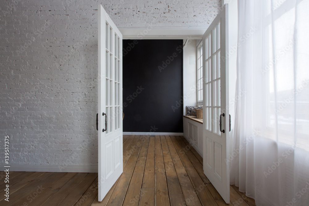 Opened white doors in empty room Opened white doors in empty room