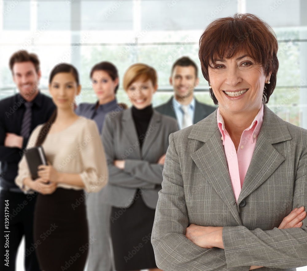 Portrait of happy senior businesswoman and team Portrait of happy senior businesswoman and team