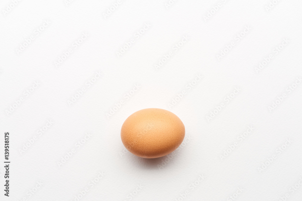 Single simple brown egg on white background Single simple brown egg on white background