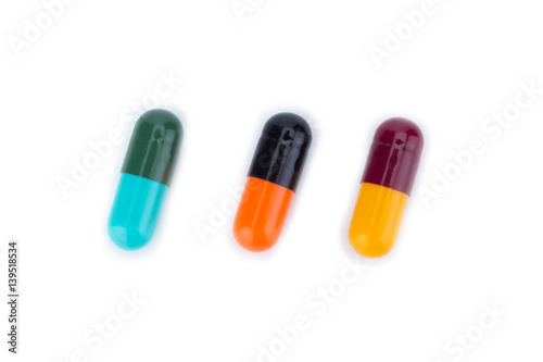 Three capsule color Red Yellow Blue Green Orange and Balck isolated on white background