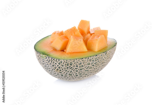half and cube cut ripe cantaloupe on a white background