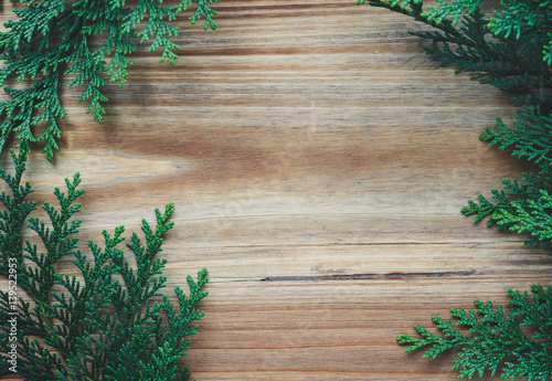 Top view on wooden background decorated pine branches