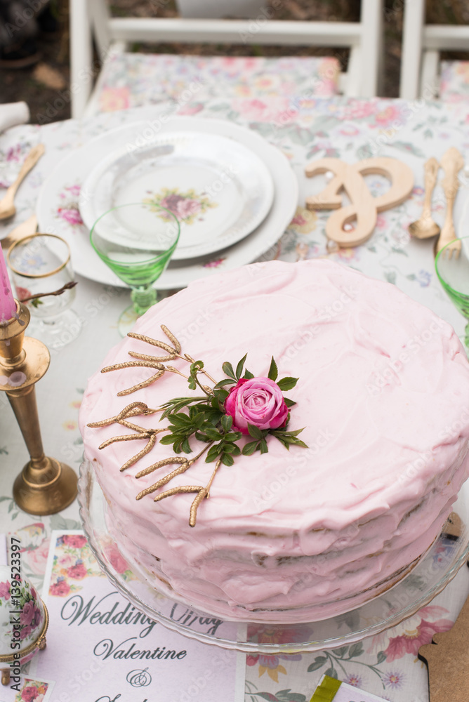 Pink wedding cake with rose on the top Pink wedding cake with rose on the top