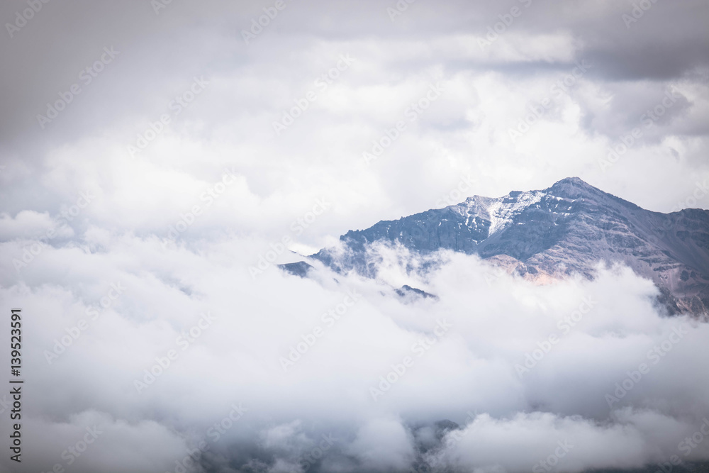 Mountain peak on a cloudy sky. Summer weather in the Peruvian Andes, south of Arequipa. Horizontal image.