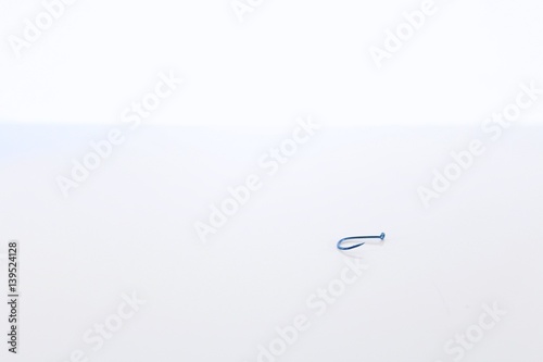 Blue Fishing Hook Isolated on White Background photo