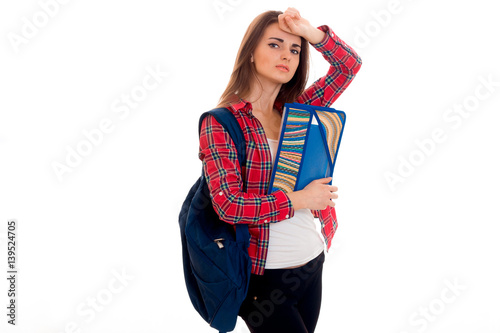 lovely young brunette students teenager in stylish clothes and backpack on her shoulders posing isolated on white background