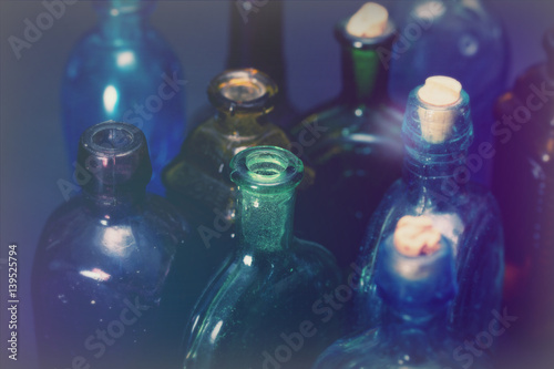 Old colourful bottles against a dark background