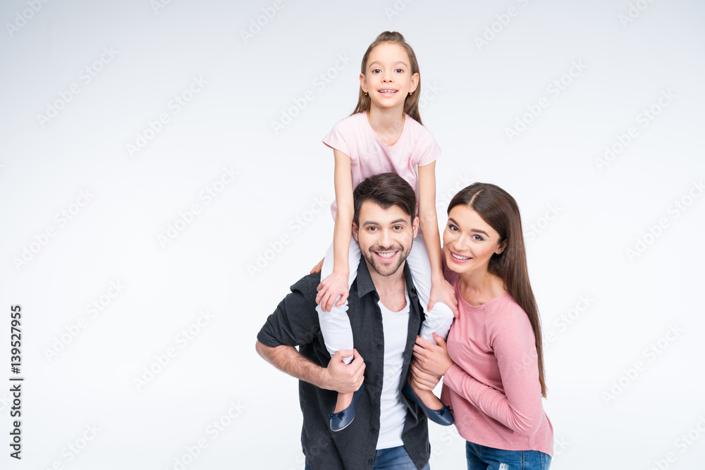 Happy young family with one child having fun together and smiling