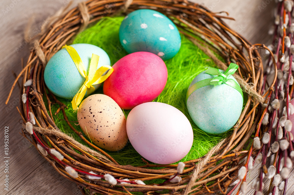 Easter composition of the branches,Easter bunny, cakes, tulips colored eggs cooked for the holiday on the wooden background Easter composition of the branches,Easter bunny, cakes, tulips colored eggs cooked for the holiday on the wooden background