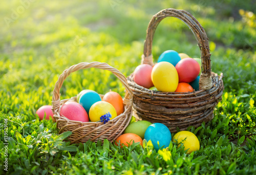 Colorful Easter eggs in wicker baskets, in open air.