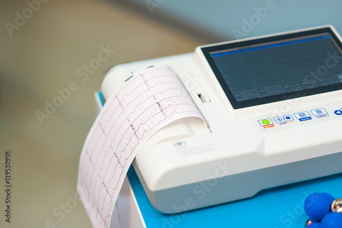 Electrocardiogram, cardiac cardiograph and conduct research in pediatrics, a girl doing an electrocardiogram