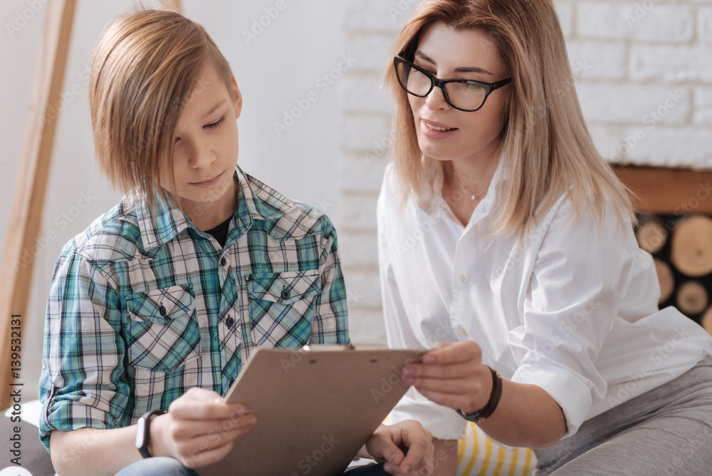 Positive expert sitting near young patient Positive expert sitting near young patient
