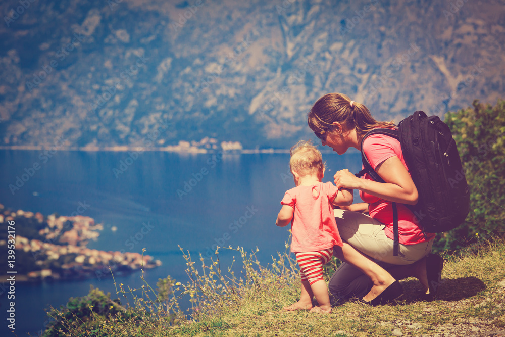 mother and little daughter travel in mountains