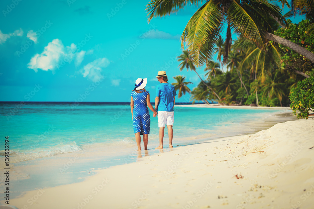 happy loving couple walking on summer beach happy loving couple walking on summer beach