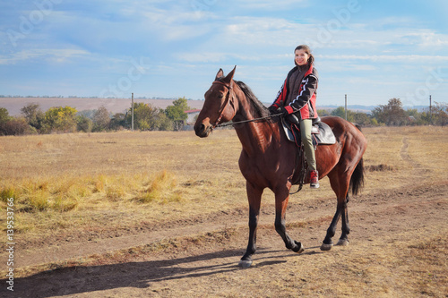 Young female rider on bay horse © roman_kharlamov