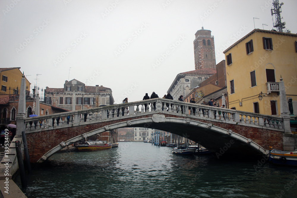Scenic canals and bridges of foggy Venice, Italy